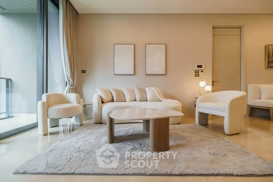 Luxurious modern living room with elegant furniture and large windows.