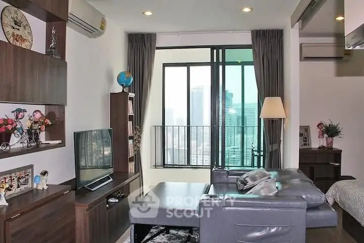 Modern living room with city view, featuring sleek furniture and large windows for natural light.