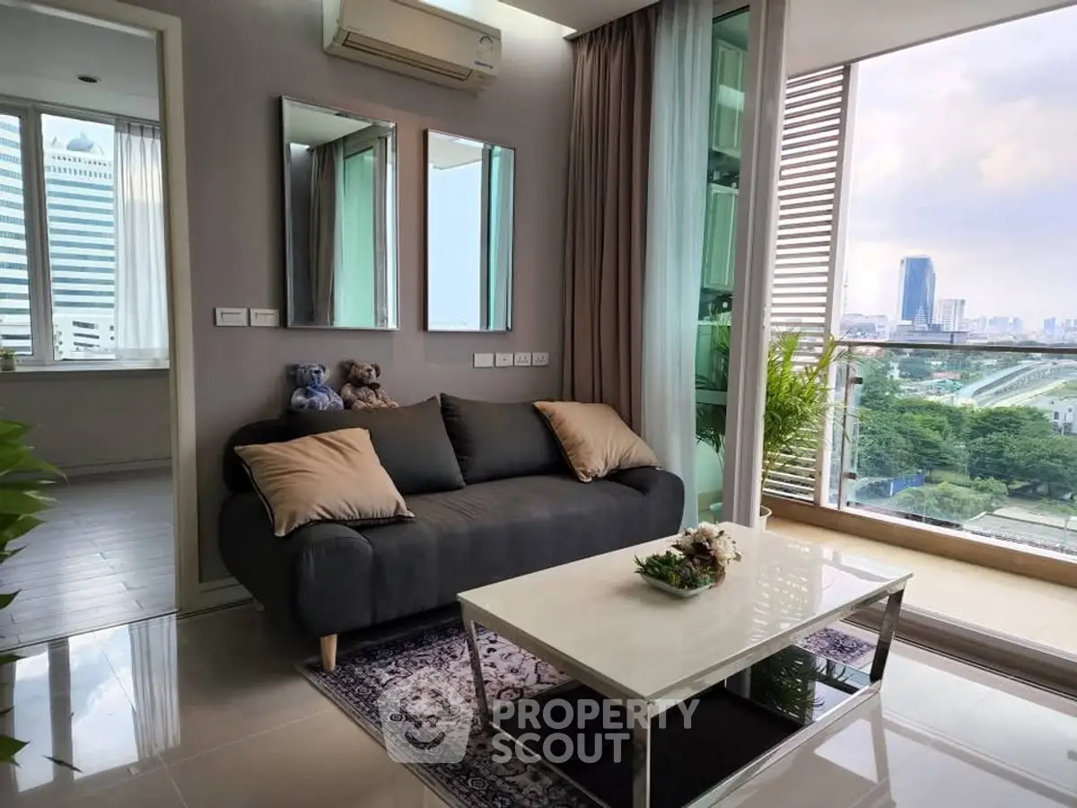 Modern living room with city view, stylish decor, and cozy seating area.