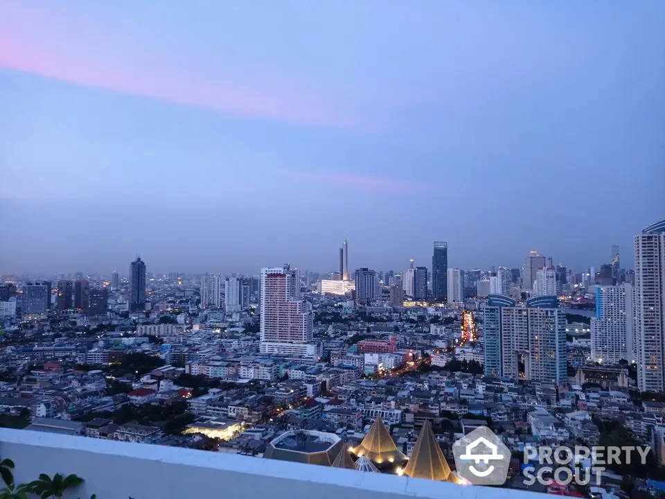 Stunning cityscape view from a high-rise building at dusk, showcasing vibrant urban skyline.