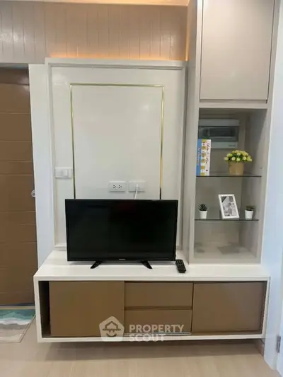 Modern living room with sleek TV stand and built-in storage, perfect for stylish urban living.