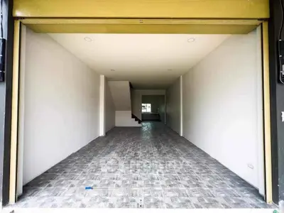 Spacious open-plan interior with modern tiled flooring and staircase, perfect for versatile use.