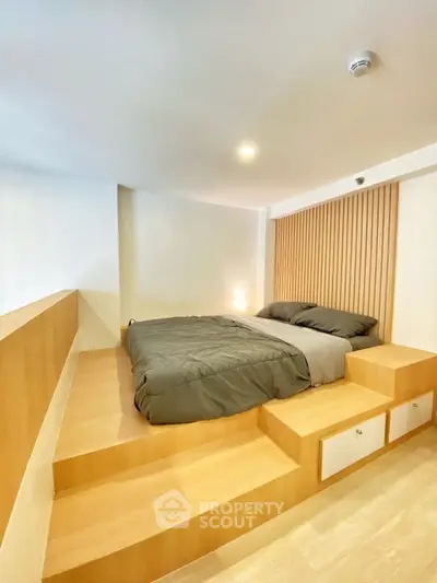 Modern bedroom with elevated platform bed and sleek wooden accents