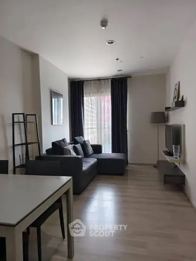 Modern living room with sleek furniture and natural light, perfect for relaxation and entertainment.