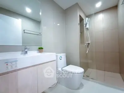 Modern bathroom with sleek fixtures and spacious shower area