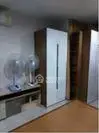 Spacious bedroom with modern wardrobe and cooling fans