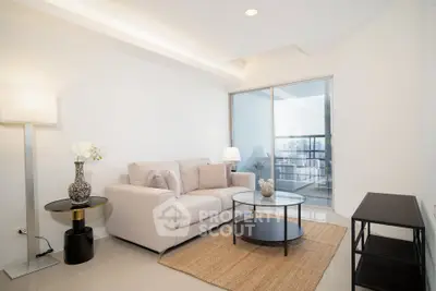 Modern living room with elegant decor and natural light, featuring a cozy sofa and stylish coffee table.