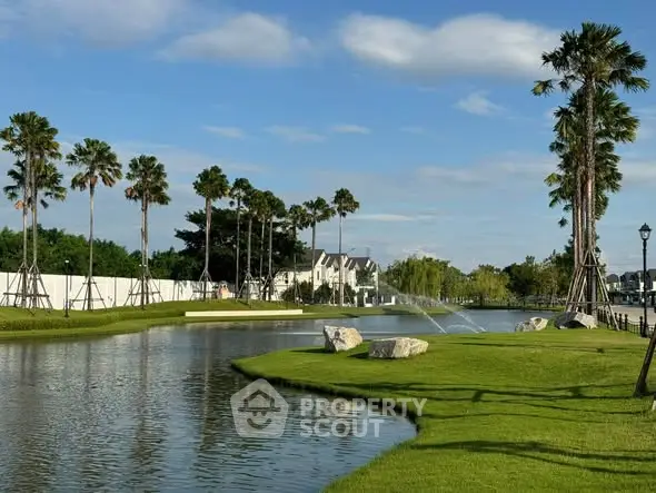 Stunning garden view with palm trees and serene water feature in luxury real estate setting.