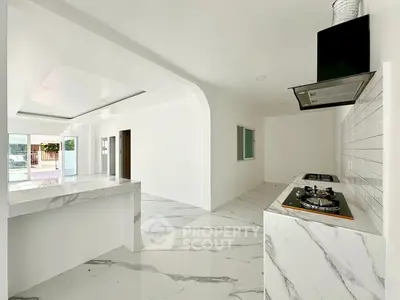 Modern kitchen with marble flooring and gas stove in open layout design