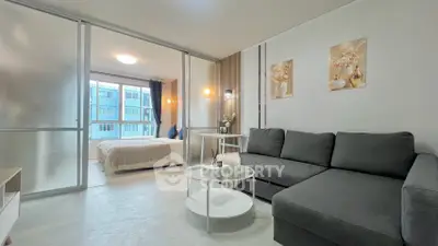 Modern living room with sleek design and cozy bedroom view, perfect for urban living.
