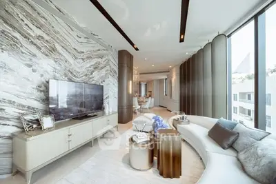 Luxurious modern living room with elegant decor and large windows offering stunning views.