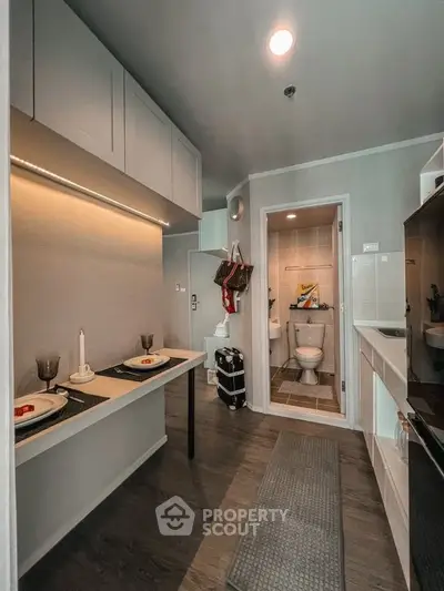 Modern compact kitchen with open layout and adjacent bathroom