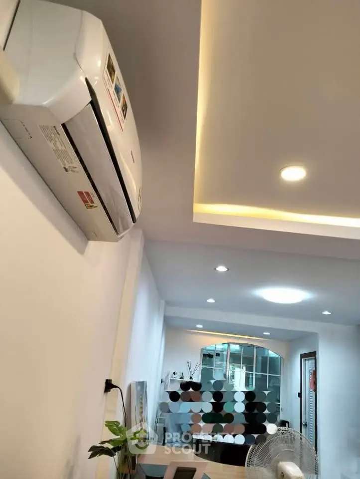 Modern interior with air conditioning and stylish ceiling lights in a cozy living space.