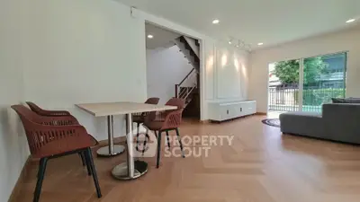 Spacious modern living room with elegant wooden flooring and stylish dining area.