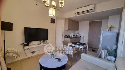 Modern living room with elegant decor, featuring a wall-mounted TV, stylish chandelier, and cozy dining area.
