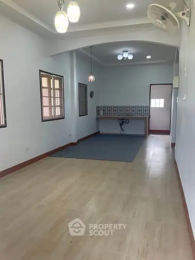 Spacious open layout living area with tiled flooring and modern lighting
