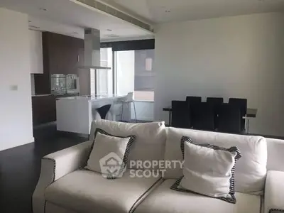 Modern open-plan living room with sleek kitchen and dining area