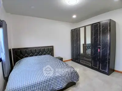 Spacious bedroom with modern decor and large wardrobe