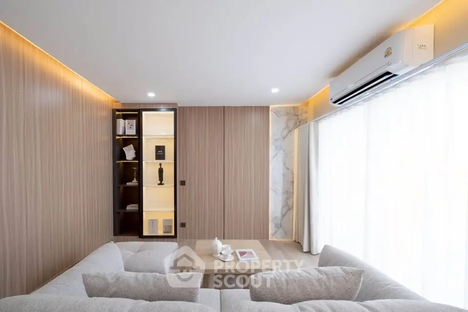 Modern living room with elegant wood paneling and cozy sectional sofa