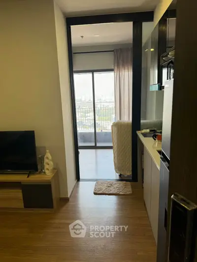 Modern apartment interior with open kitchen and balcony view