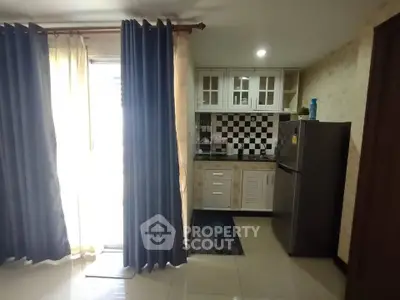 Cozy kitchen with checkered backsplash and modern appliances in a bright apartment.