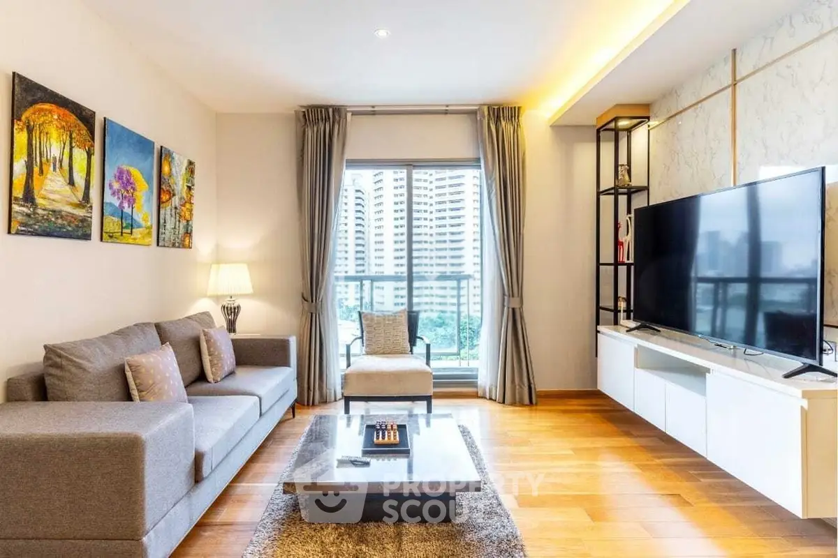 Spacious modern living room with large TV and city view, perfect for urban living.