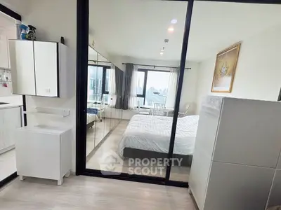 Modern bedroom with glass partition and city view in stylish apartment