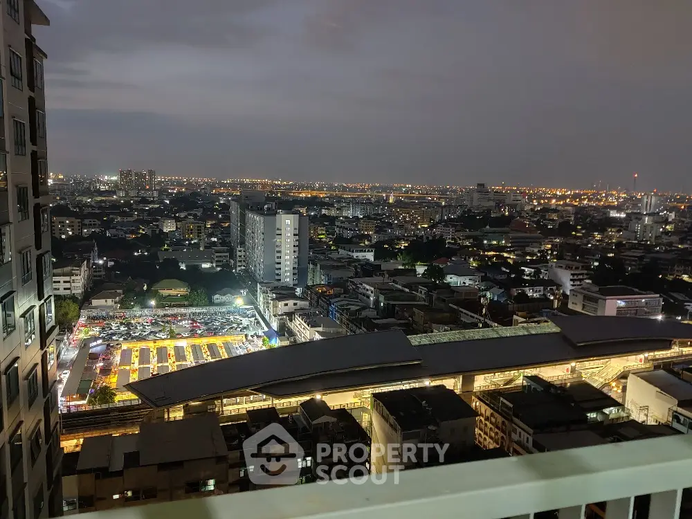Stunning cityscape view from high-rise balcony at dusk with vibrant city lights.