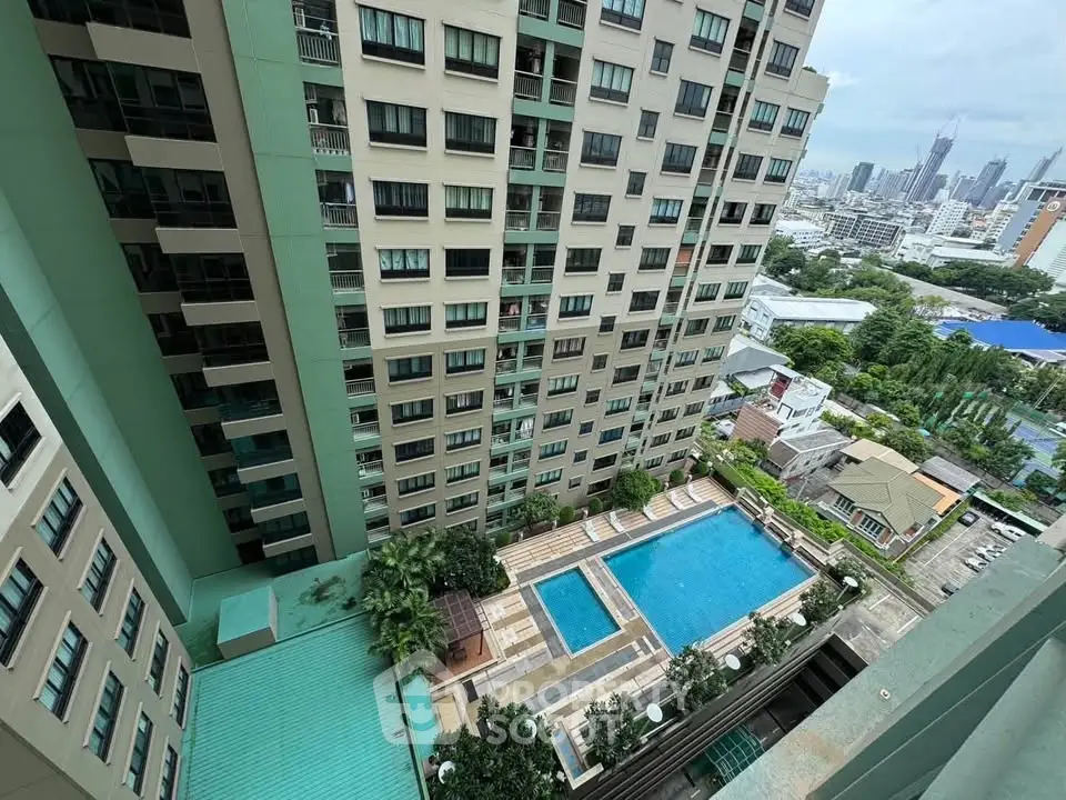 High-rise building with pool and city view, perfect for urban living.