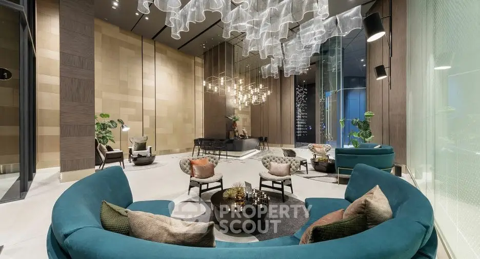 Luxurious modern living room with elegant furniture and stunning chandelier lighting.