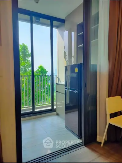 Modern kitchen with balcony view and sleek appliances