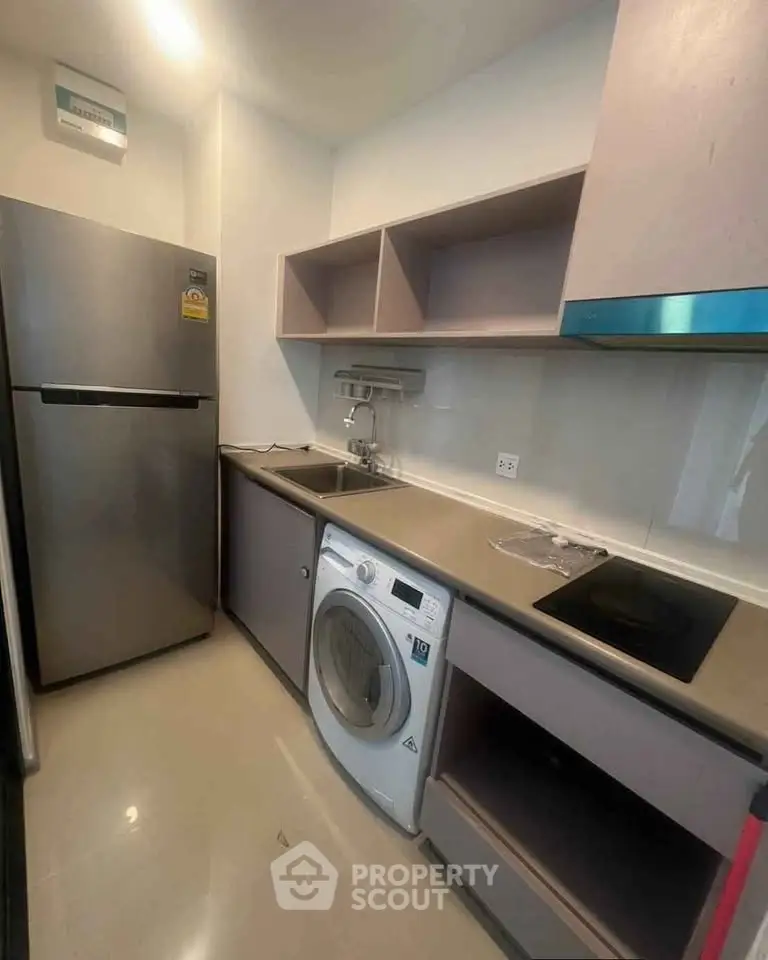 Modern kitchen with sleek appliances and efficient layout in a stylish apartment.