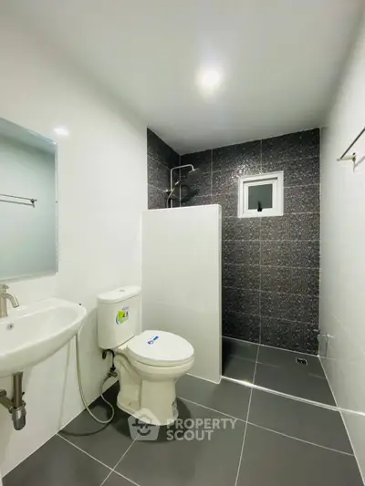 Modern bathroom with sleek design and dark accent wall