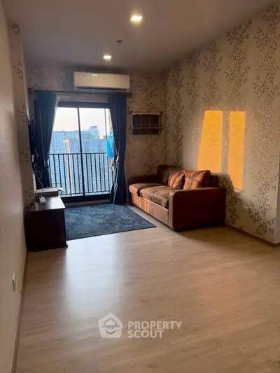 Spacious living room with balcony view and stylish decor