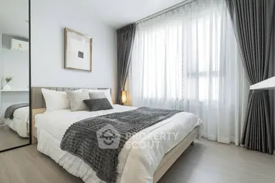 Modern bedroom with elegant decor and large window for natural light