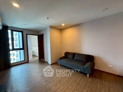 Spacious modern living room with wooden flooring and cozy sofa