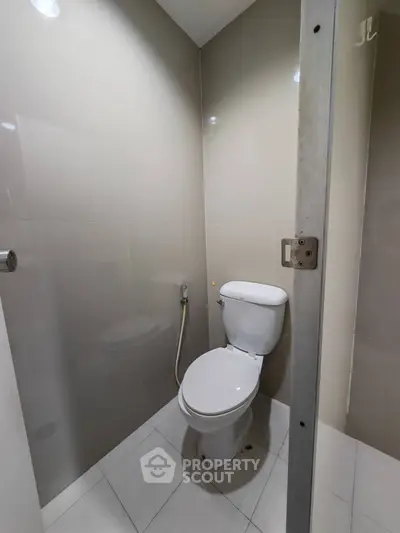Compact modern bathroom with sleek design and neutral tiles