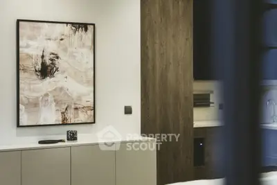 Modern interior with abstract art and sleek cabinetry in a stylish living space.