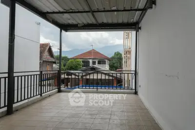 Spacious balcony with mountain view in a residential area, perfect for relaxation.