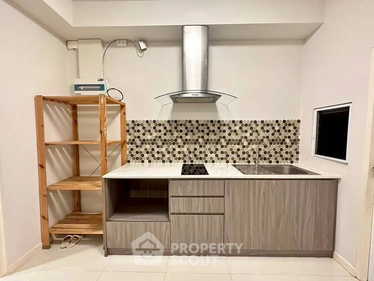 Modern kitchen with sleek cabinetry and stylish backsplash