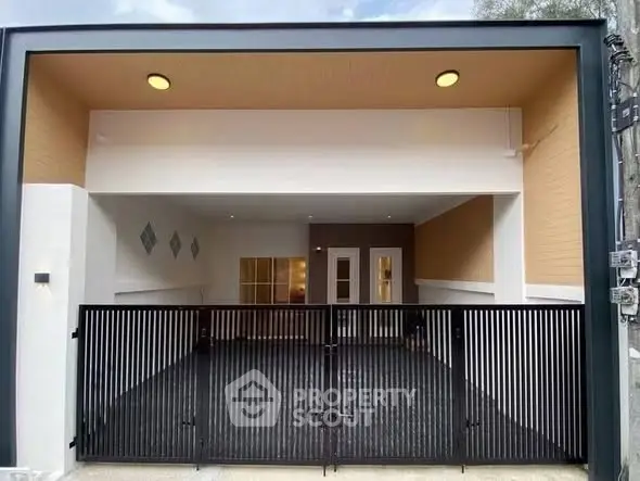 Modern covered parking space with sleek black gate and contemporary design.