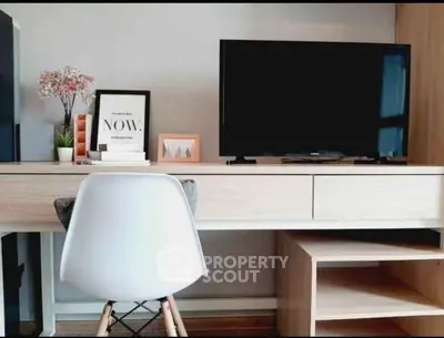 Modern study area with sleek desk, chair, and TV setup