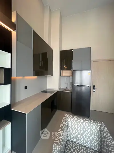 Modern kitchen with sleek cabinets and stainless steel appliances in a stylish apartment.