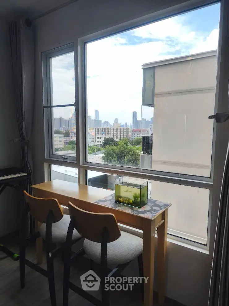 Charming apartment with city view and cozy dining nook by the window.
