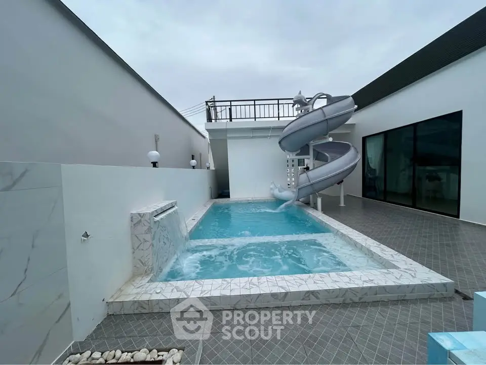 Luxurious private pool with slide in modern home exterior
