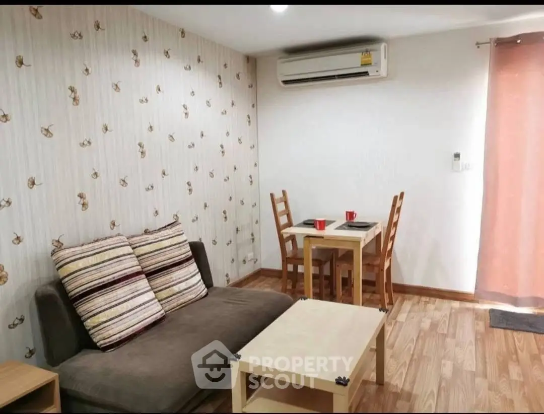 Cozy living room with modern decor and air conditioning, perfect for relaxation.