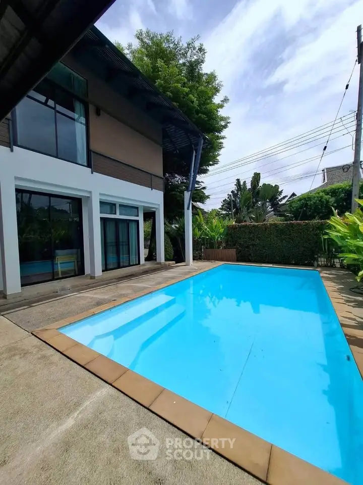 Modern house with private pool and lush garden, perfect for luxury living.