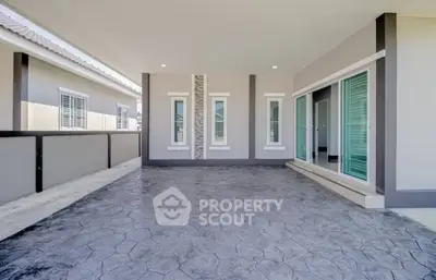 Spacious modern balcony with sliding glass doors and stylish flooring.