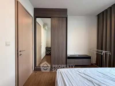 Modern bedroom with sleek wooden wardrobe and minimalist decor
