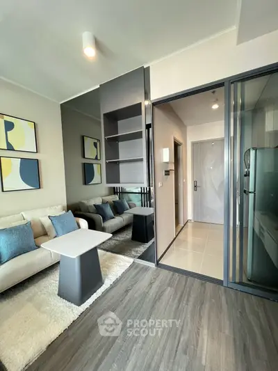 Modern living room with stylish decor and open layout, featuring cozy seating and elegant flooring.